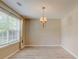 Dining room showcasing neutral walls, wood laminate floors, and natural lighting at 6684 Crane Ave, Fairburn, GA 30213