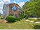 Charming two-story brick home with well-manicured lawn, lush landscaping, and blue shutters at 6684 Crane Ave, Fairburn, GA 30213
