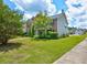 Beautiful two-story home with brick accents, lush green lawn, and mature trees at 6684 Crane Ave, Fairburn, GA 30213