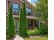Charming brick home with mature landscaping, including three Leyland Cypress trees in the front yard at 6684 Crane Ave, Fairburn, GA 30213