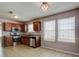 Well-lit kitchen with stainless steel appliances, wood cabinets, and plenty of counter space at 6684 Crane Ave, Fairburn, GA 30213