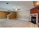 Cozy living room features a fireplace, ceiling fan, and neutral wall tones at 6684 Crane Ave, Fairburn, GA 30213