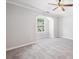 Bedroom with a tray ceiling, ceiling fan, carpet floors, and a window at 5057 Lower Elm St, Atlanta, GA 30349
