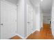 Bright hallway featuring hardwood floors and white doors, leading to various rooms at 5057 Lower Elm St, Atlanta, GA 30349