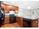Bright kitchen featuring granite countertops, wood cabinets, and stainless steel appliances at 5057 Lower Elm St, Atlanta, GA 30349