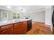 Island kitchen view with granite countertop, stainless steel dishwasher, and hardwood floors at 5057 Lower Elm St, Atlanta, GA 30349