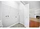 Functional laundry room with tile flooring, wire shelving, and connections for washer and dryer at 5057 Lower Elm St, Atlanta, GA 30349