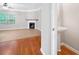 Open-concept living room featuring hardwood floors, fireplace, and a half-bath with pedestal sink at 5057 Lower Elm St, Atlanta, GA 30349