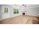 Bright living room with a door to the patio, fireplace, and hardwood floors at 5057 Lower Elm St, Atlanta, GA 30349