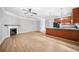 Open floorplan with a kitchen island, fireplace, and hardwood floors at 5057 Lower Elm St, Atlanta, GA 30349