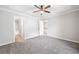 Spacious main bedroom features a tray ceiling, ceiling fan and en suite bathroom at 5057 Lower Elm St, Atlanta, GA 30349