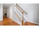 Elegant staircase with wooden handrail and gray carpet runners connecting the floors at 5057 Lower Elm St, Atlanta, GA 30349