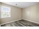 Bright bedroom featuring gray wood floors and a well-lit window at 5422 Timor Trl, Lithonia, GA 30038