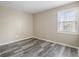 Bedroom with gray wood floors and a bright window at 5422 Timor Trl, Lithonia, GA 30038