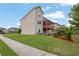 Well-maintained backyard with lush green grass, landscaped garden beds, and a wood deck at 56 Addison Woods Dr, Sugar Hill, GA 30518