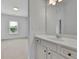 Bathroom showcasing a white vanity with storage and a large mirror, offering style and functionality at 56 Addison Woods Dr, Sugar Hill, GA 30518