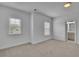Bedroom with soft carpet and natural light from two windows, leading to the ensuite bathroom at 56 Addison Woods Dr, Sugar Hill, GA 30518