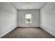Bedroom featuring neutral carpet, a window with blinds and ample space for personalization at 56 Addison Woods Dr, Sugar Hill, GA 30518