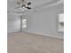 Spacious bedroom with coffered ceiling, ceiling fan, and large windows providing ample natural light at 56 Addison Woods Dr, Sugar Hill, GA 30518
