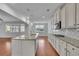 Bright kitchen with white cabinets, granite countertops, stainless steel appliances, and a large center island at 56 Addison Woods Dr, Sugar Hill, GA 30518