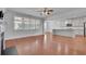 Open-concept living area flows into the kitchen, boasting hardwood floors and natural light at 56 Addison Woods Dr, Sugar Hill, GA 30518