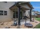 Covered patio with porch swing, grill, mini trampoline, and fenced backyard at 5925 Whitney Ct, Cumming, GA 30041
