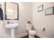 Bathroom features include pedestal sink, toilet, and tasteful wall art at 5925 Whitney Ct, Cumming, GA 30041