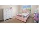 Bedroom exhibits a colorful bed set and white dresser with a coordinated dollhouse at 5925 Whitney Ct, Cumming, GA 30041