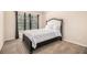 Bedroom features a modern upholstered bed, window, and neutral color scheme at 5925 Whitney Ct, Cumming, GA 30041