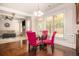 Bright breakfast nook with glass table, fuchsia chairs, and coffered ceiling at 5925 Whitney Ct, Cumming, GA 30041