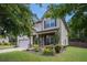 Charming two-story home features a manicured front lawn, attached garage, and inviting curb appeal at 5925 Whitney Ct, Cumming, GA 30041