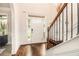 Inviting foyer featuring hardwood floors, staircase with wrought iron railing, and a view of the front door at 5925 Whitney Ct, Cumming, GA 30041