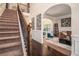 Spacious foyer showcasing hardwood floors, staircase with dark iron railing, and arched doorways at 5925 Whitney Ct, Cumming, GA 30041