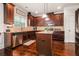 Spacious kitchen boasts stainless steel appliances, wooden cabinets, granite countertops, and hardwood floors at 5925 Whitney Ct, Cumming, GA 30041