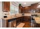 Modern kitchen with stainless steel appliances, granite countertops, and dark wood cabinets at 5925 Whitney Ct, Cumming, GA 30041