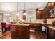 Well-equipped kitchen with dark cabinets, granite countertops, island, and stainless steel appliances at 5925 Whitney Ct, Cumming, GA 30041