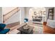 Open-concept space with hardwood floors showcasing a dining area, staircase, and neutral furnishings at 5925 Whitney Ct, Cumming, GA 30041