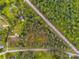 Aerial view of a wooded land parcel with paved road frontage and mature trees at 13 Westbrook Rd, Carrollton, GA 30116