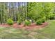 Backyard featuring a cozy bench nestled among trees and bushes, creating a peaceful retreat for relaxation at 13 Westbrook Rd, Carrollton, GA 30116