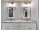 Bathroom with double vanity featuring granite countertops and modern lighting fixtures at 13 Westbrook Rd, Carrollton, GA 30116