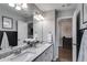 Bathroom with double vanity, large mirror, overhead lighting and gray walls at 13 Westbrook Rd, Carrollton, GA 30116