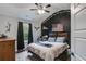 Charming bedroom featuring a queen-size bed, dark accent wall, and a ceiling fan at 13 Westbrook Rd, Carrollton, GA 30116