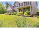 Beautifully landscaped front yard featuring colorful plants and green grass, showcasing the home's curb appeal at 13 Westbrook Rd, Carrollton, GA 30116