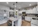 Well-lit kitchen boasts stainless steel appliances, granite countertops, hardwood floors and decorative hanging lights at 13 Westbrook Rd, Carrollton, GA 30116