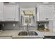 Kitchen sink with granite countertops and subway tile backsplash at 13 Westbrook Rd, Carrollton, GA 30116