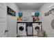 Laundry room with a washer and dryer, storage shelves and gray walls at 13 Westbrook Rd, Carrollton, GA 30116