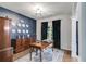 Stylish home office with navy accent wall, antique furniture, and natural light creating an inviting work space at 13 Westbrook Rd, Carrollton, GA 30116
