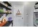 View of the pantry with black shelving, a Farmers Market bag on the door and a beverage refrigerator at 13 Westbrook Rd, Carrollton, GA 30116