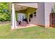 Cozy covered patio with comfortable seating and outdoor dining area at 13 Westbrook Rd, Carrollton, GA 30116
