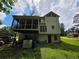 View of rear exterior with screened porch, siding, and green lawn under a blue sky at 3692 Belmont Abbey Dr, Decatur, GA 30034